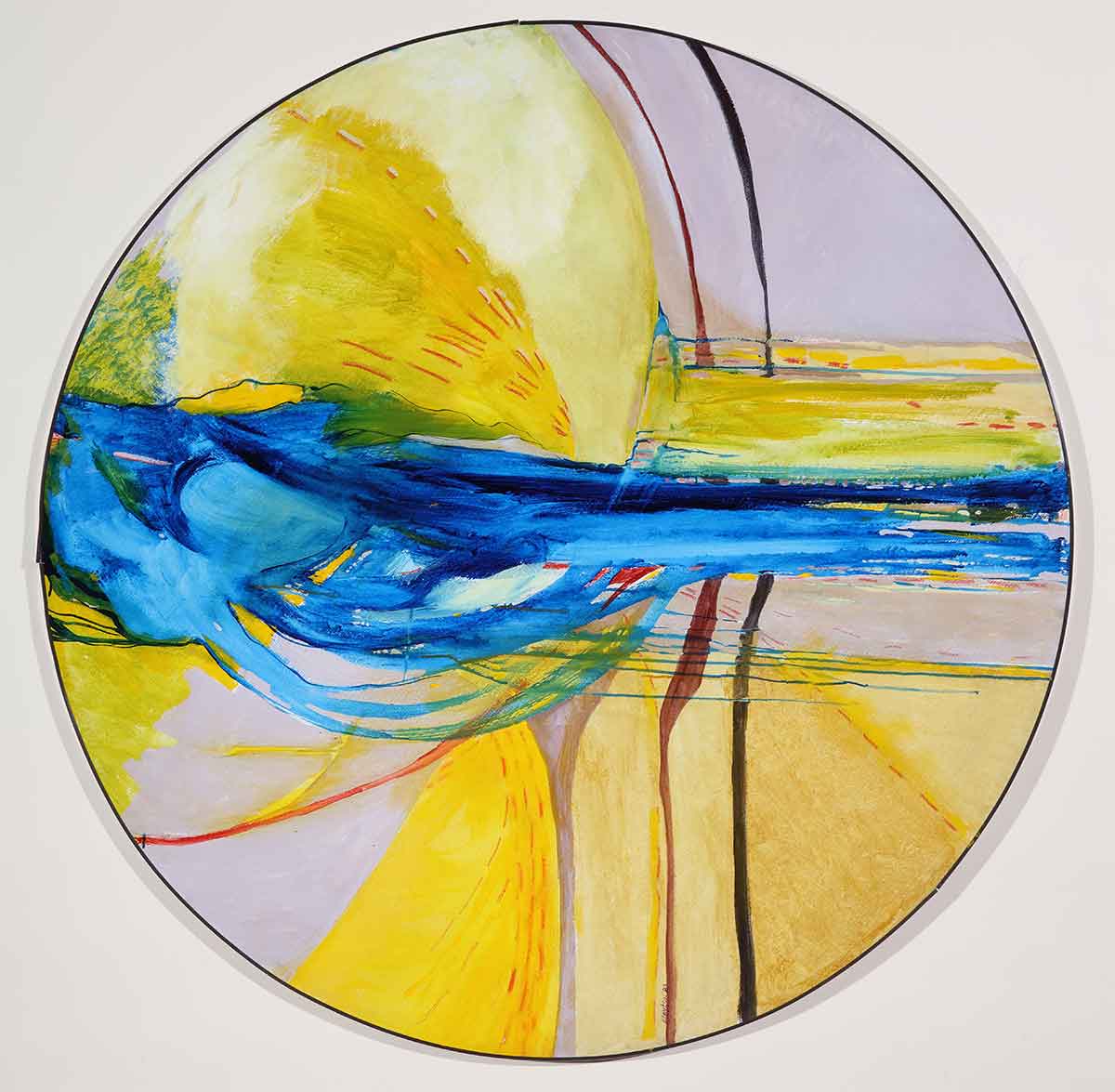 A circular canvas with a bright yellow and blue abstract painting on it