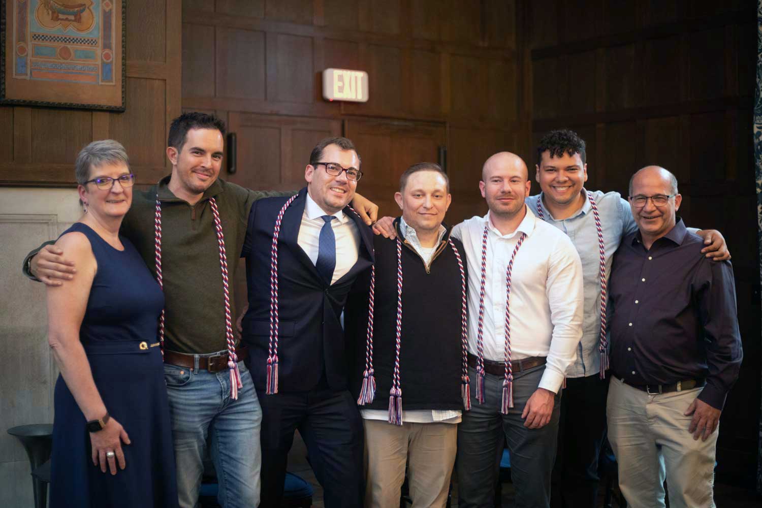 group of people wearing red/white/blue cords posing for the camera