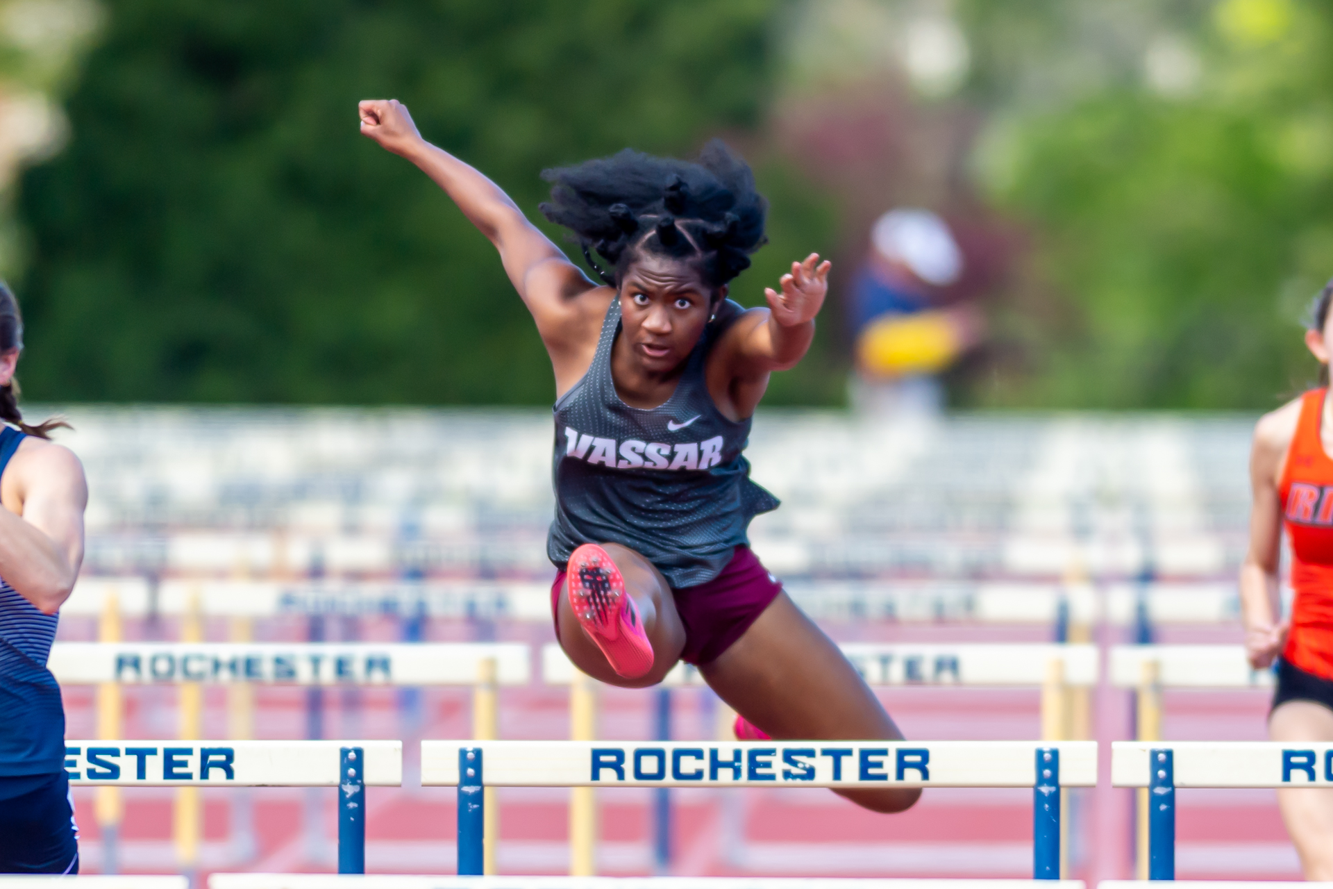 Jahmilia Dennis leaps over a hurdle.