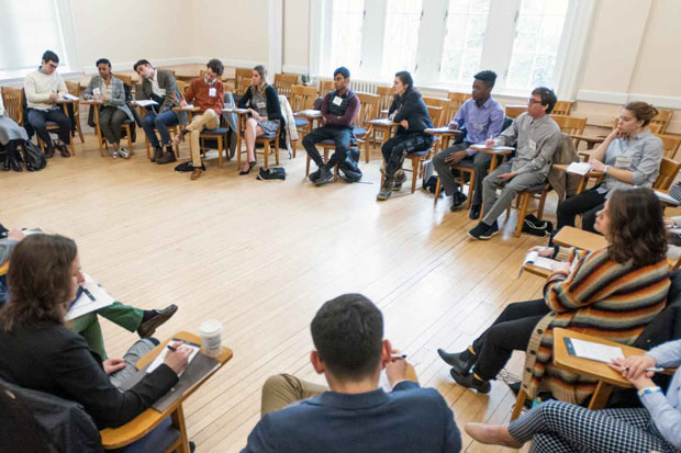 Large group of people seated in a circle during a meeting