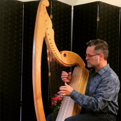 James Ruff playing the harp.