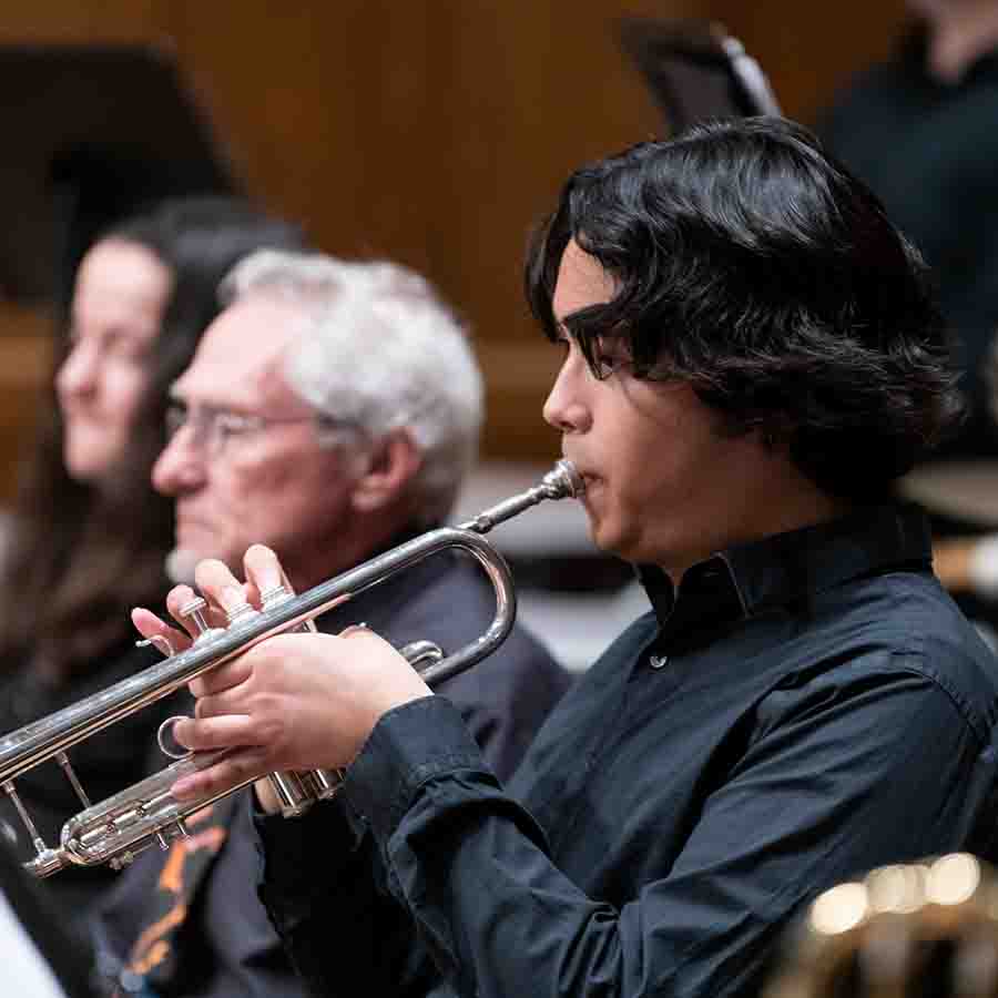 Man playing a trumpet in an orchestra