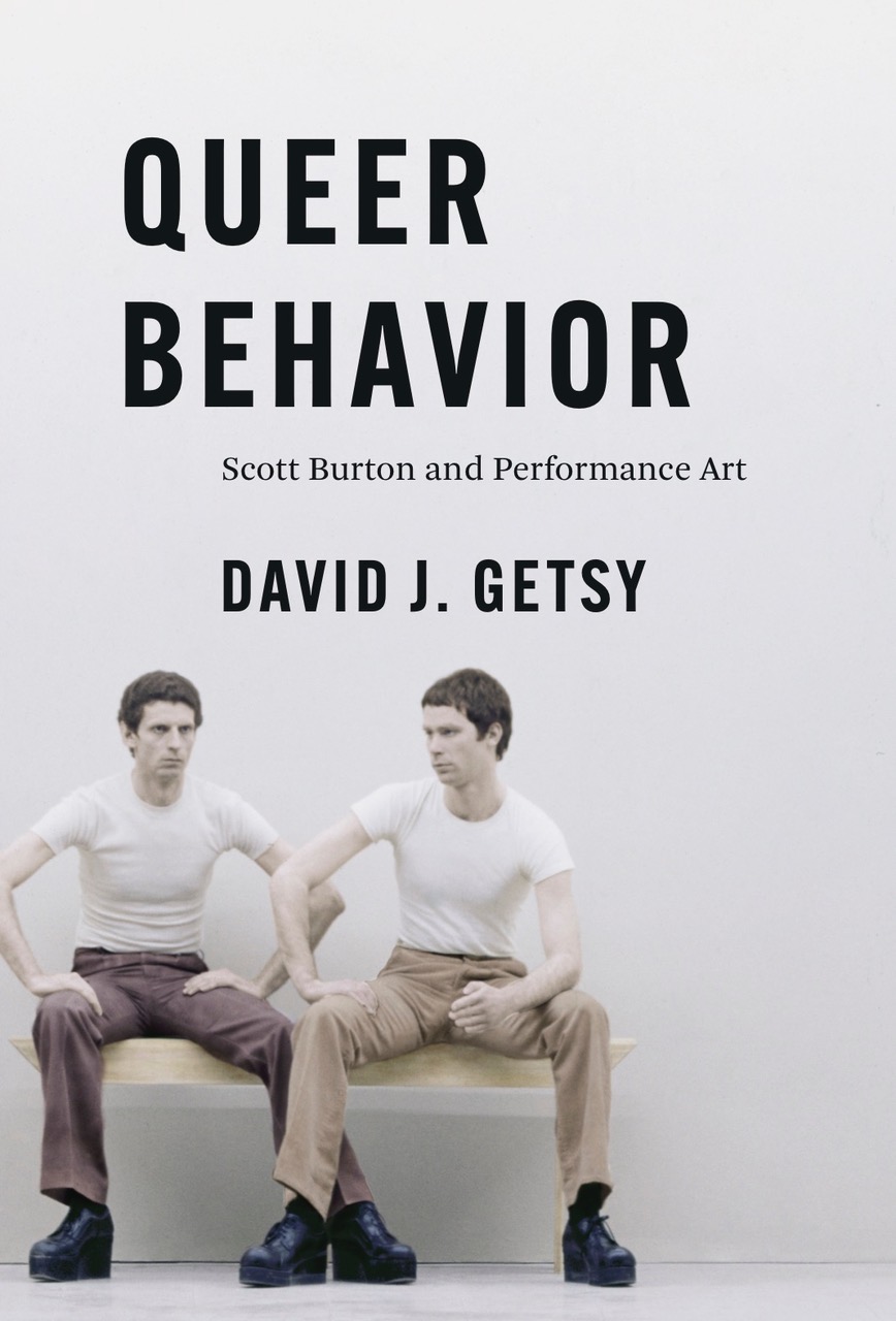 Book jacket with the title “Queer Behavior: Scott Burton and Performance Art” by David J. Getsy and a photo of two look-alike men seated on a bench staring into space.