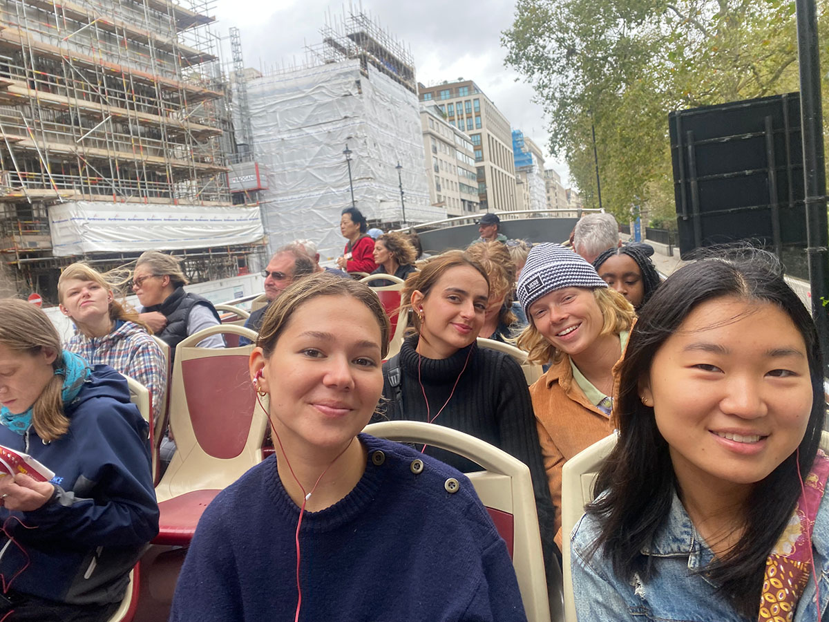 Group of people on top of a double decker bus in London