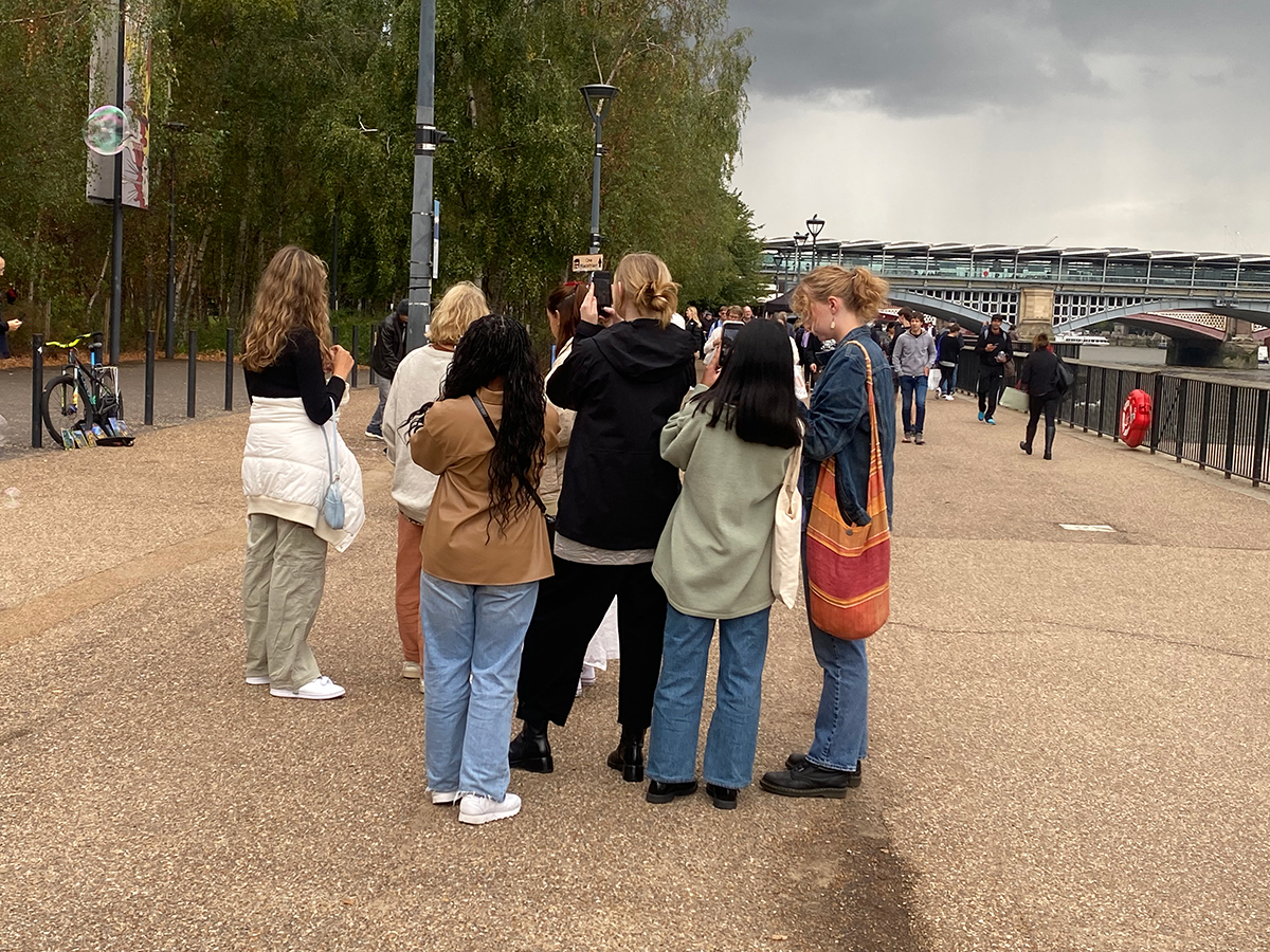 Group of people in London with their back towards the camera
