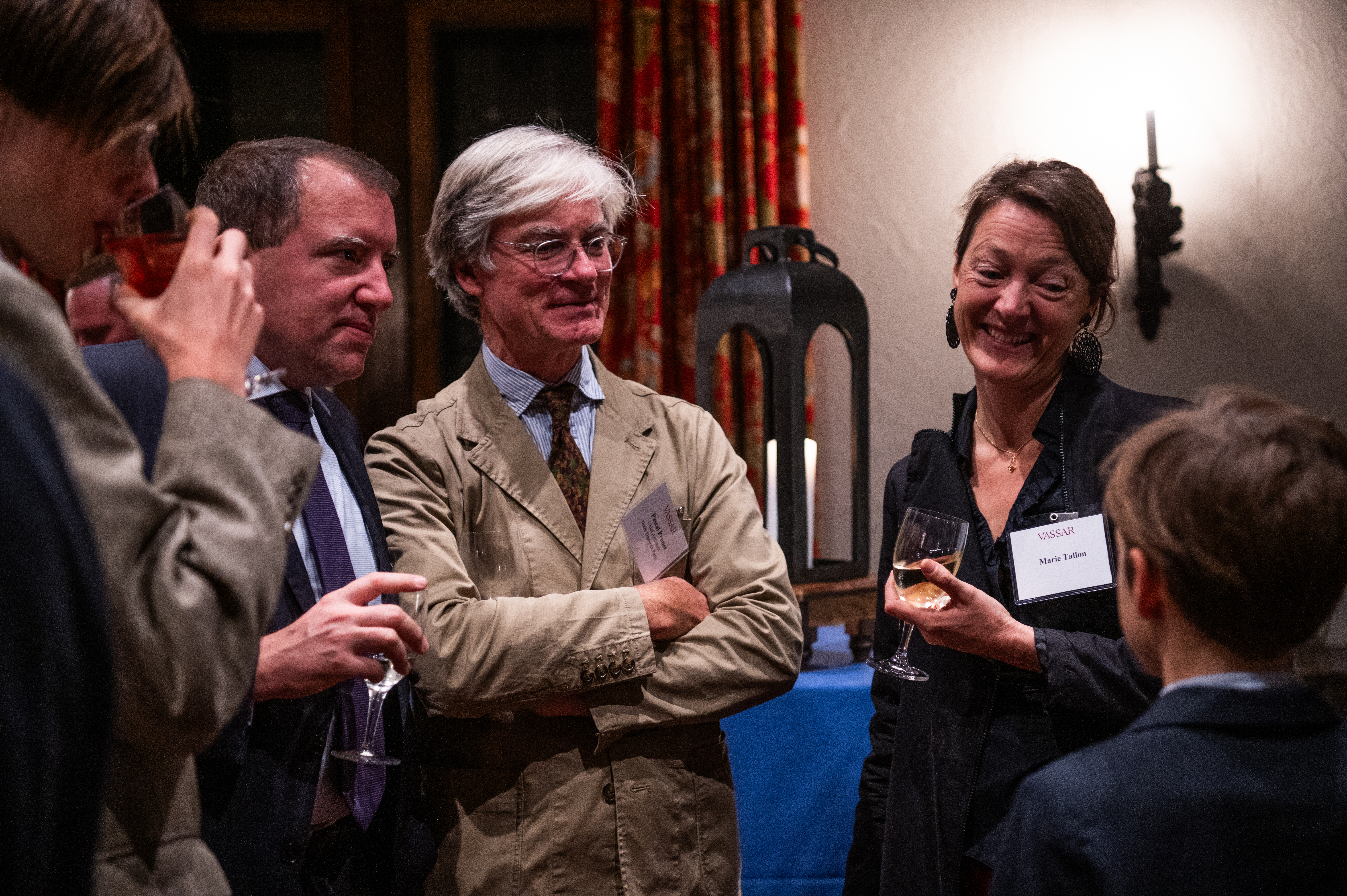 A group of people mingling together in conversation at a reception.