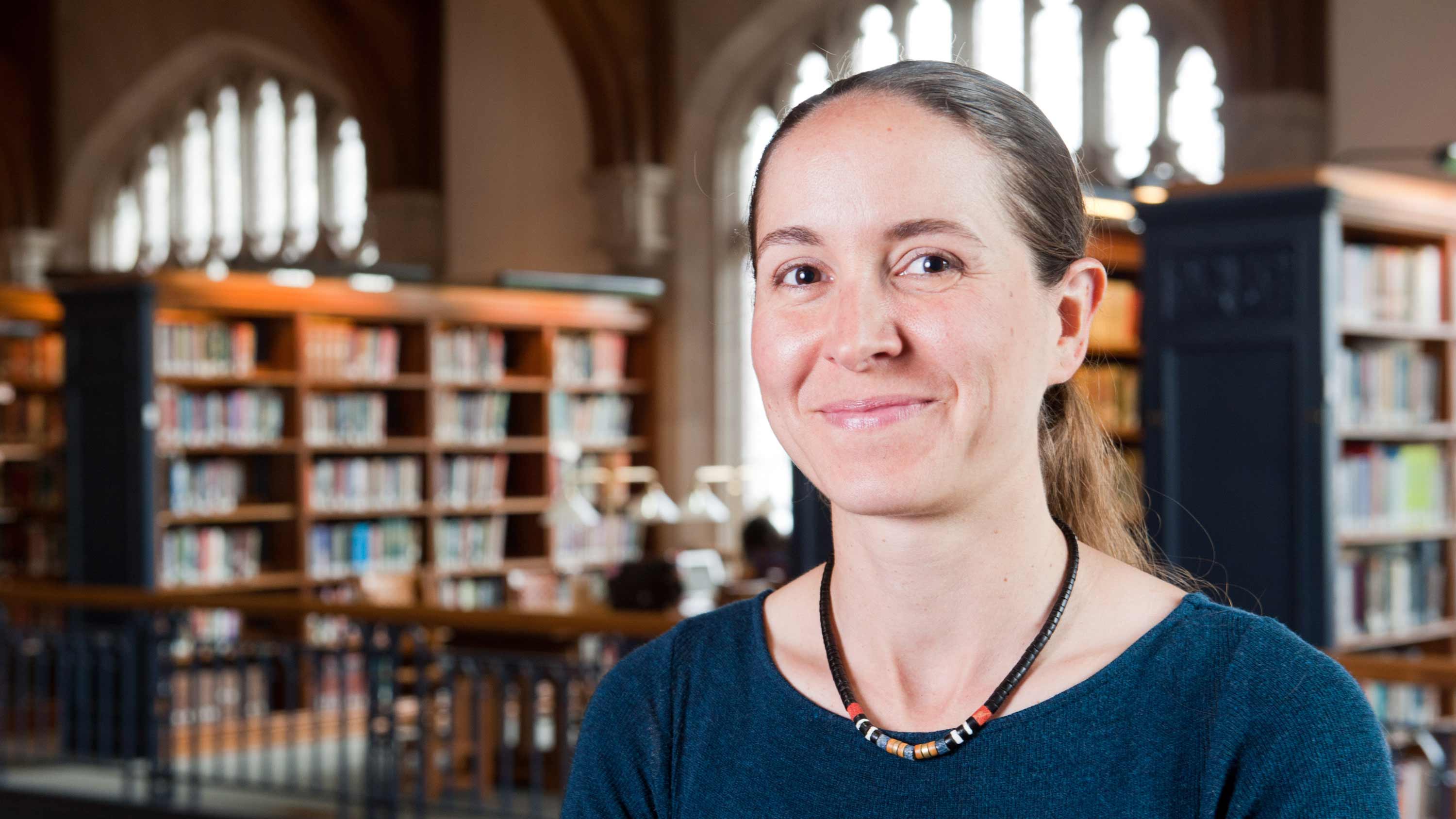 Colette Salyk, Associate Professor of Astronomy and Chair of Physics and Astronomy on the Marisa Mitchell Chair at Vassar College poses in the library.