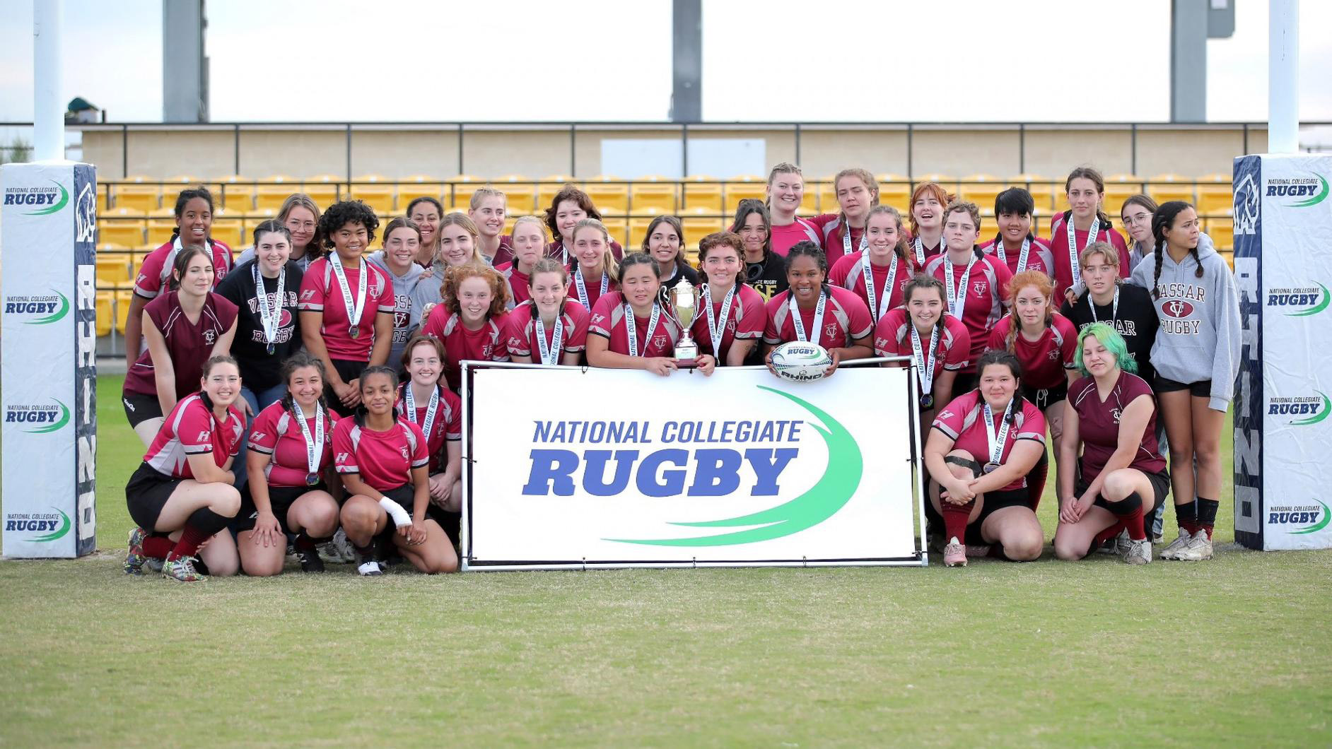 The entire Vassar Rugby Team posing in the field.