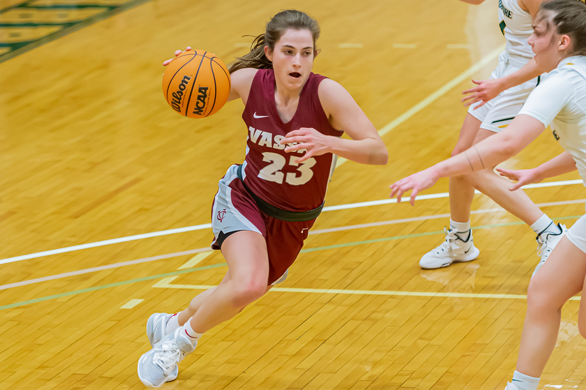 Julia Harvey dribbles the ball during a game as opponents try to steal it.