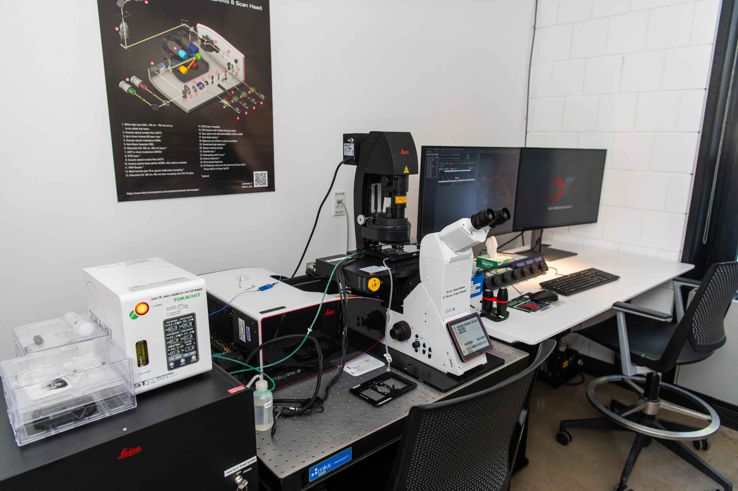 High tech microscope with a computer screen.