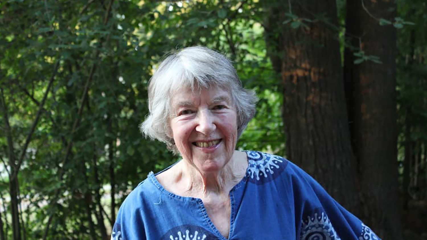 A portrait photo of Jan Farrington ’46 taken in the woods.