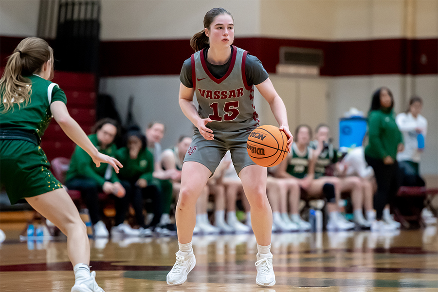 Action shot of Sierra McDermed dribbling a basketball.