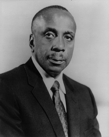 Old black and white portrait of a man in a suit and tie.