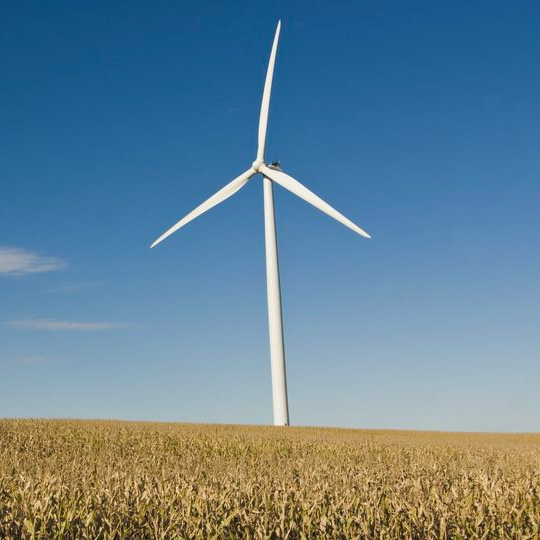 3 blade windmill against a blue sky.