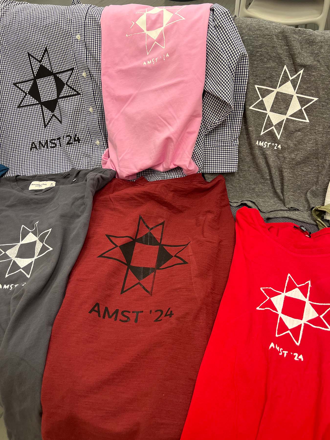 Gray, pink, and red screen printed t-shirts.