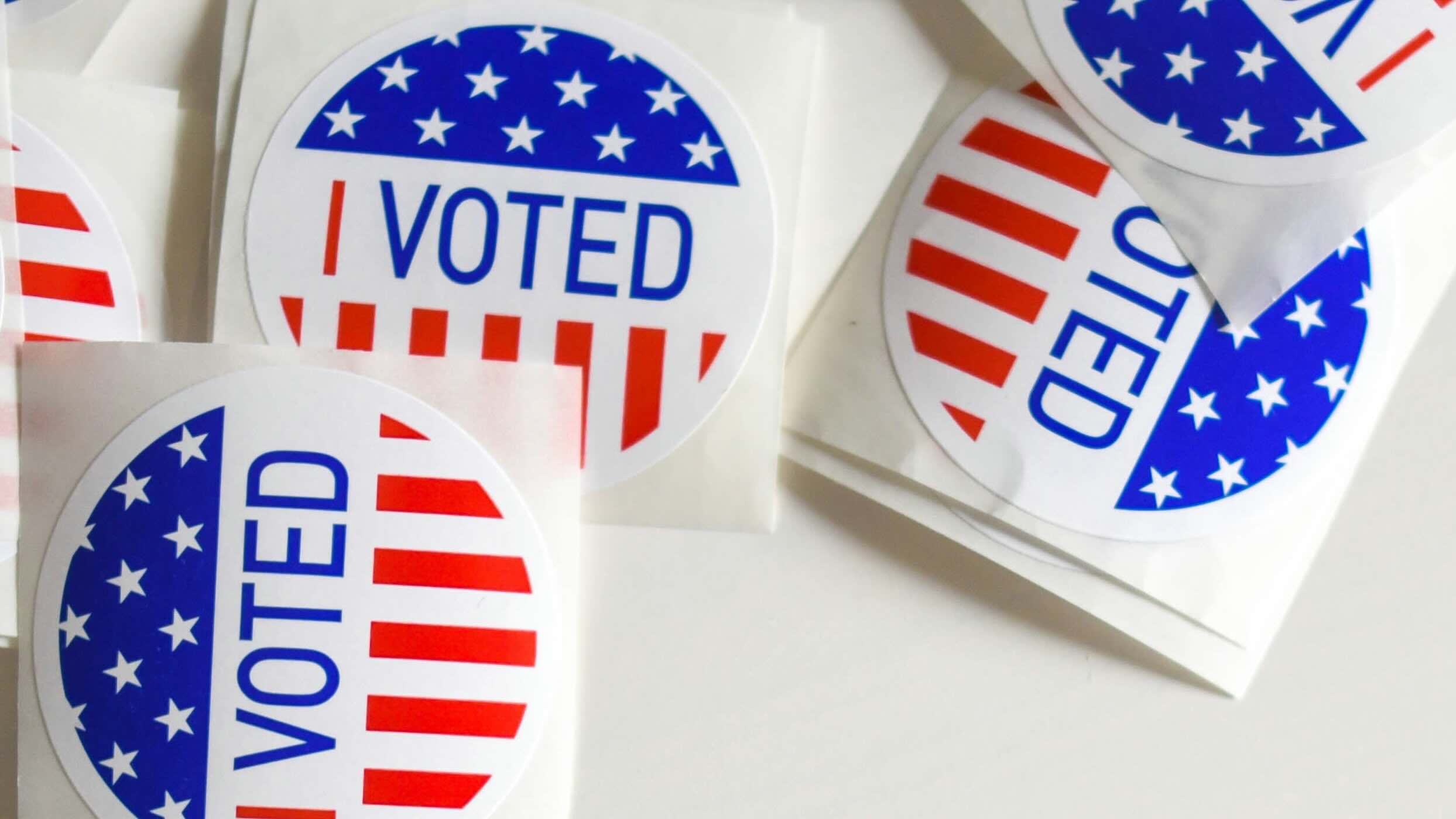 Scattered selection of red, white, and blue stickers that read: I voted.