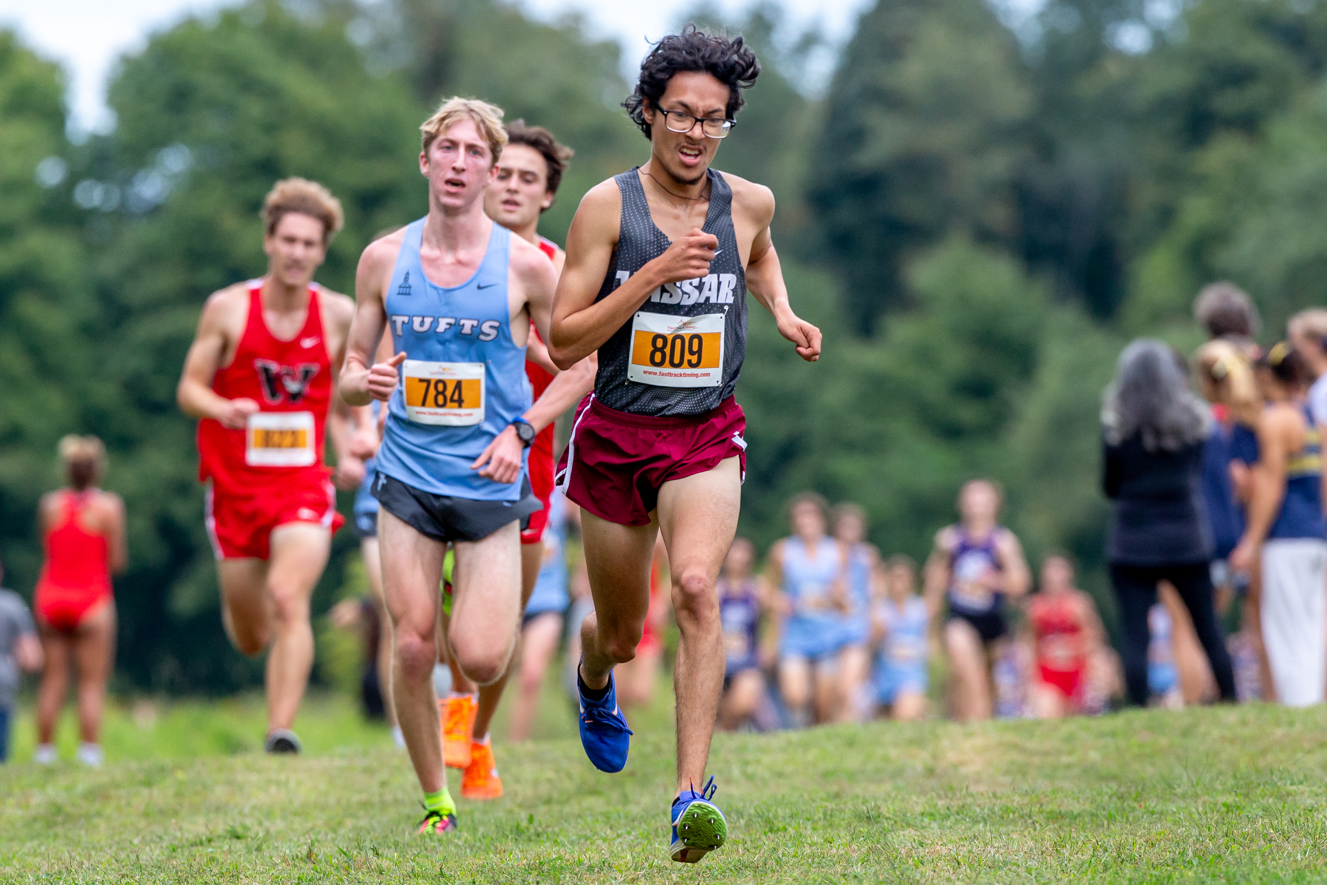 Vassar runner Jose Magana leads a pack of competitors during a cross-country race.
