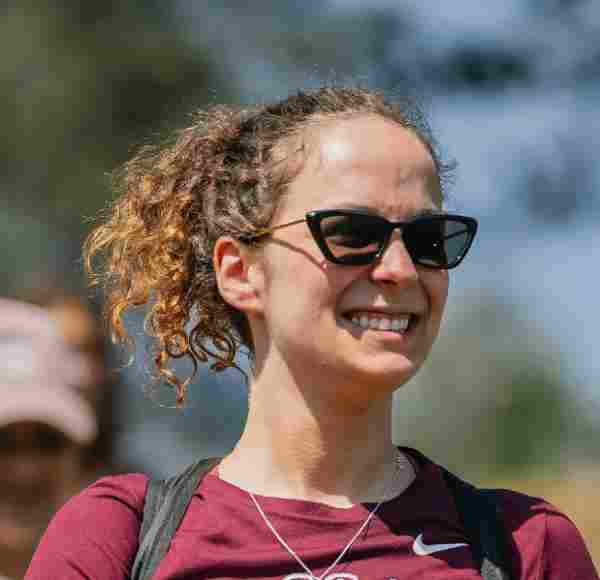 A photo of Talia Yustein ’26, a person with long blond curly hair and sunglasses.