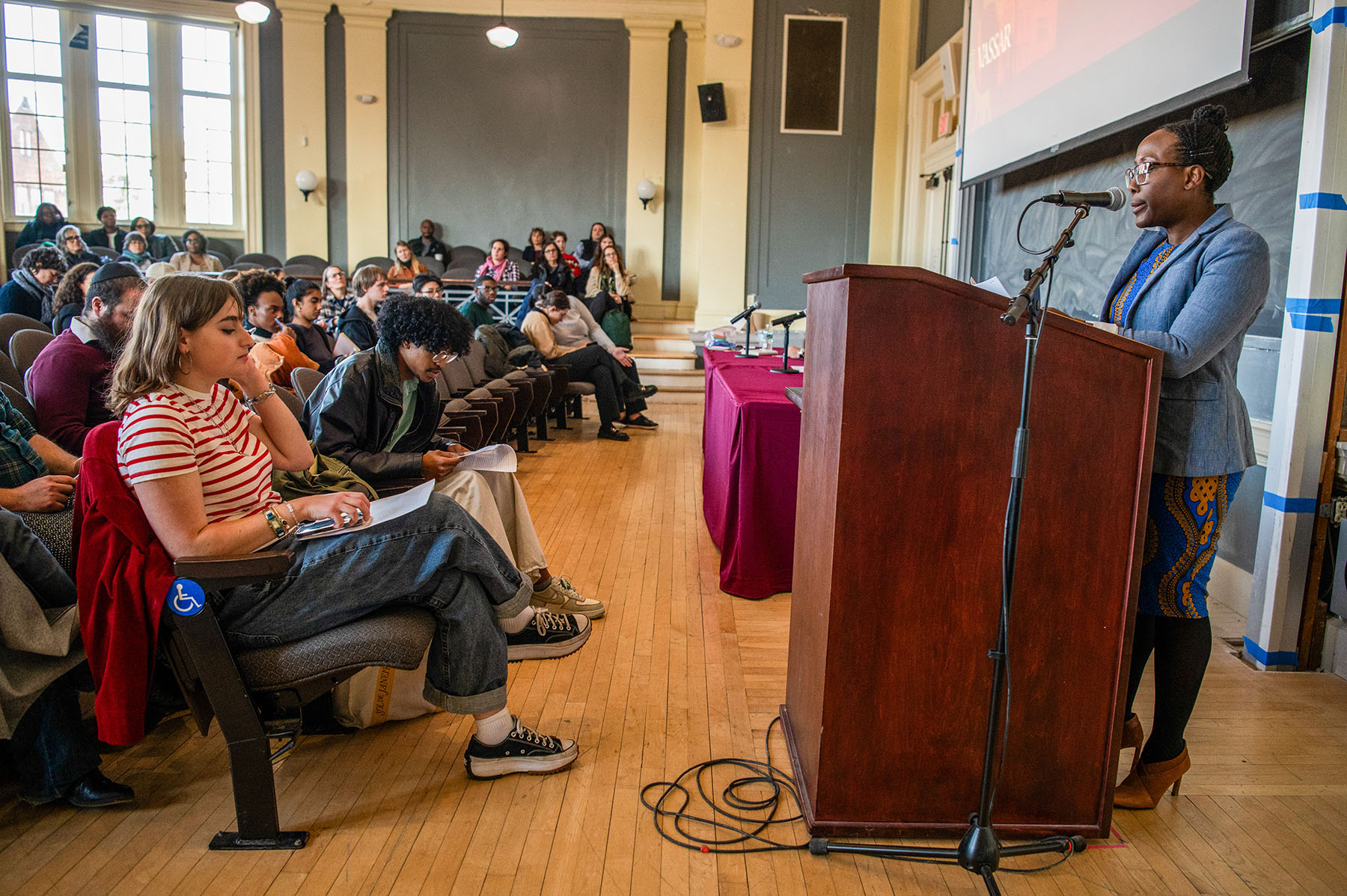 Auditory classroom with a speaker at a podium.