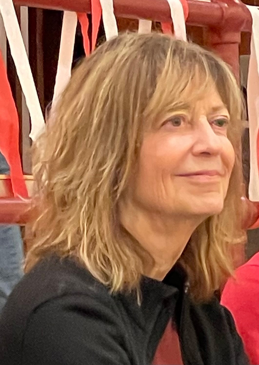 Pictured: Patricia Wallace. Person smiling and looking away from the camera.