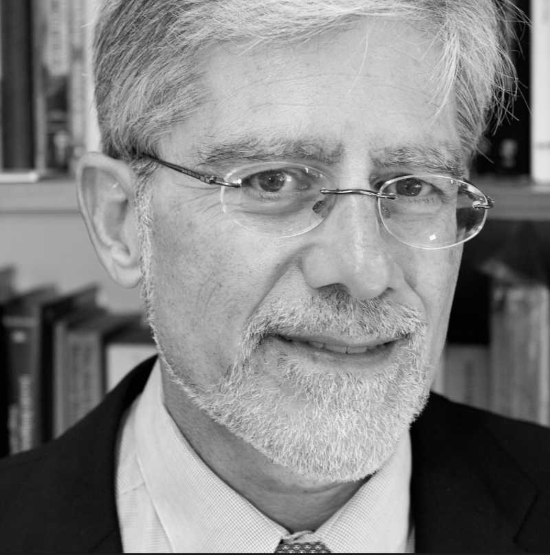 A black and white photo of Professor Kenneth Stow, a person with short gray hair, glasses, and a mustache and beard.