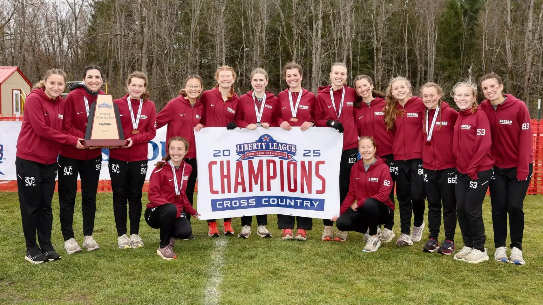 Team photo with athletes holding a banner that reads: 2025 Liberty League Champions Cross Country.