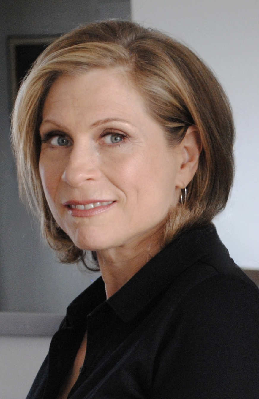 A photo of Amy Burton, a person with mid-length blond hair and a black shirt.