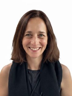 A portrait of Kira Pollock, a person with long brown hair and a black dress.