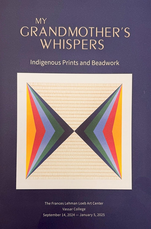 Brochure cover for “My Grandmother’s Whispers: Indigenous Prints and Beadwork” at the Frances Lehman Loeb Art Center, Vassar College (September 14, 2024–January 5, 2025). The design features light text on a deep purple background above a geometric artwork of mirrored triangular shapes in layered bands of yellow, red, blue, green, and black on a cream, ruled field.
