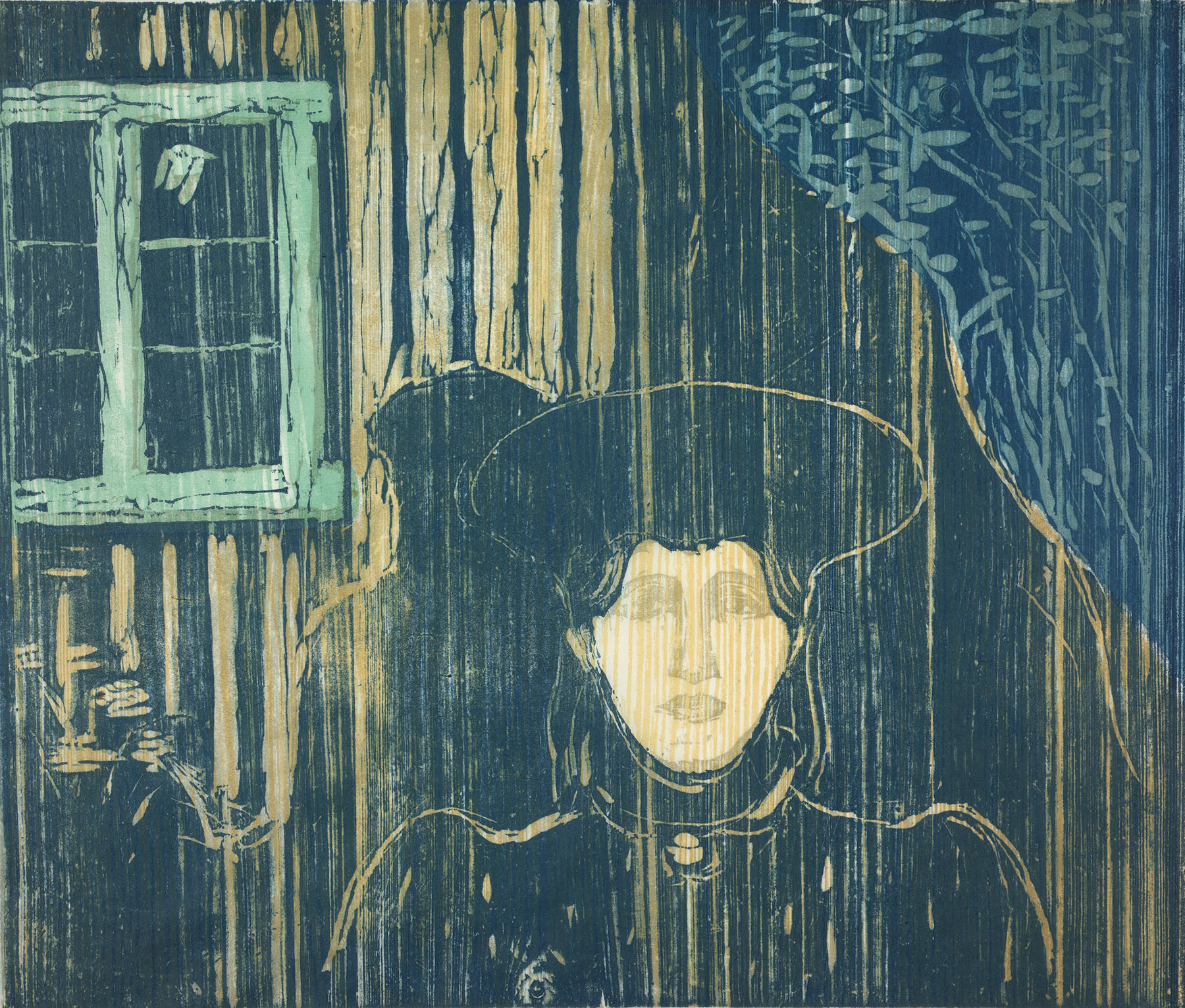 Edvard Munch, Moonlight I-II, 1896. A color woodcut depicting a solitary figure wearing a wide-brimmed dark hat and dark coat, rendered in deep teal, blue, and golden yellow. The figure's pale, luminous face gazes outward beneath the hat's brim. Behind the figure, vertical wood grain streaks suggest a wall or fence. To the upper left, a green-framed window is visible, and to the upper right, leafy branches drape downward. The overall mood is atmospheric and brooding.