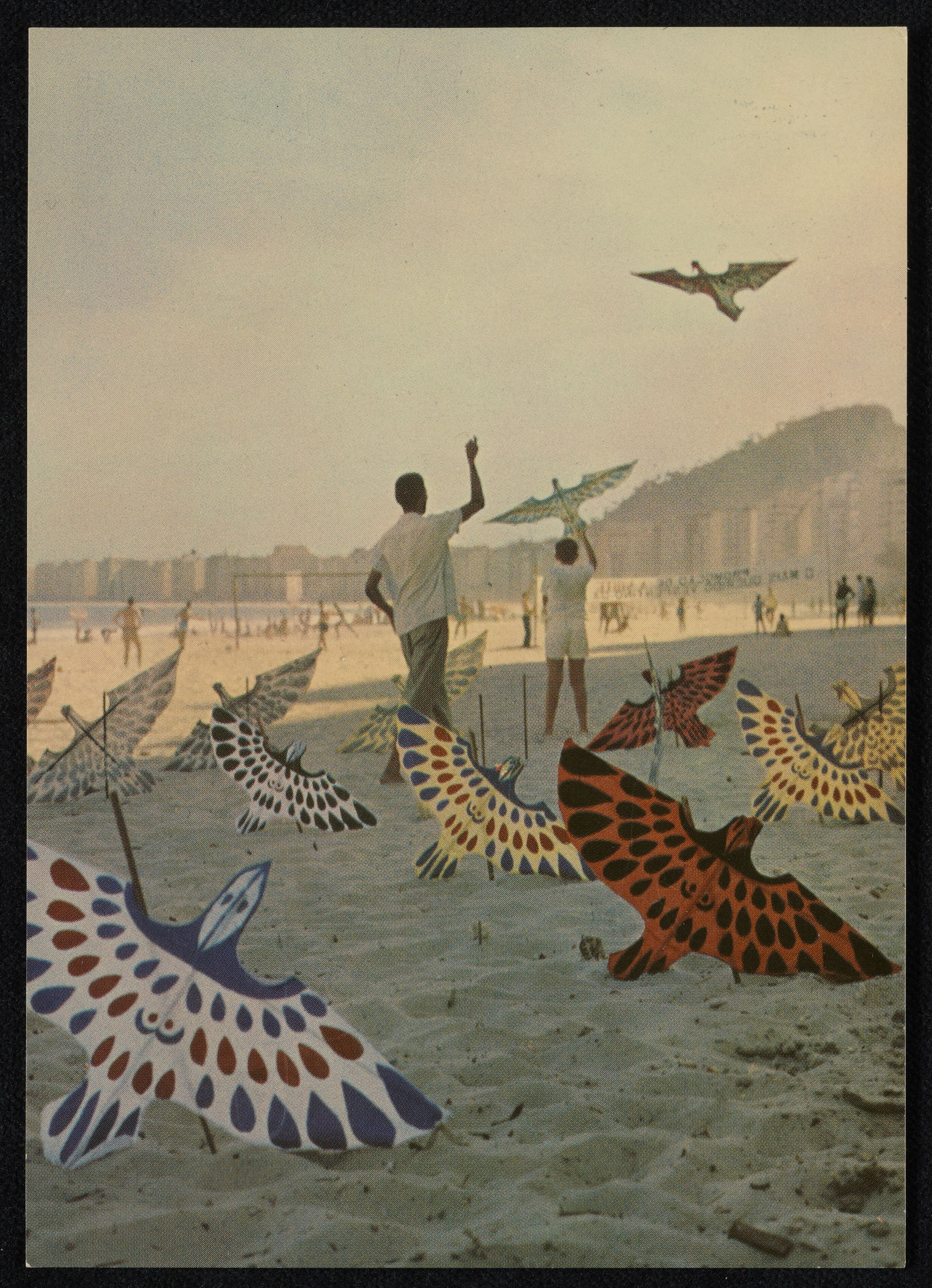 A colorful painting of an adult and child flying kites on a beach.