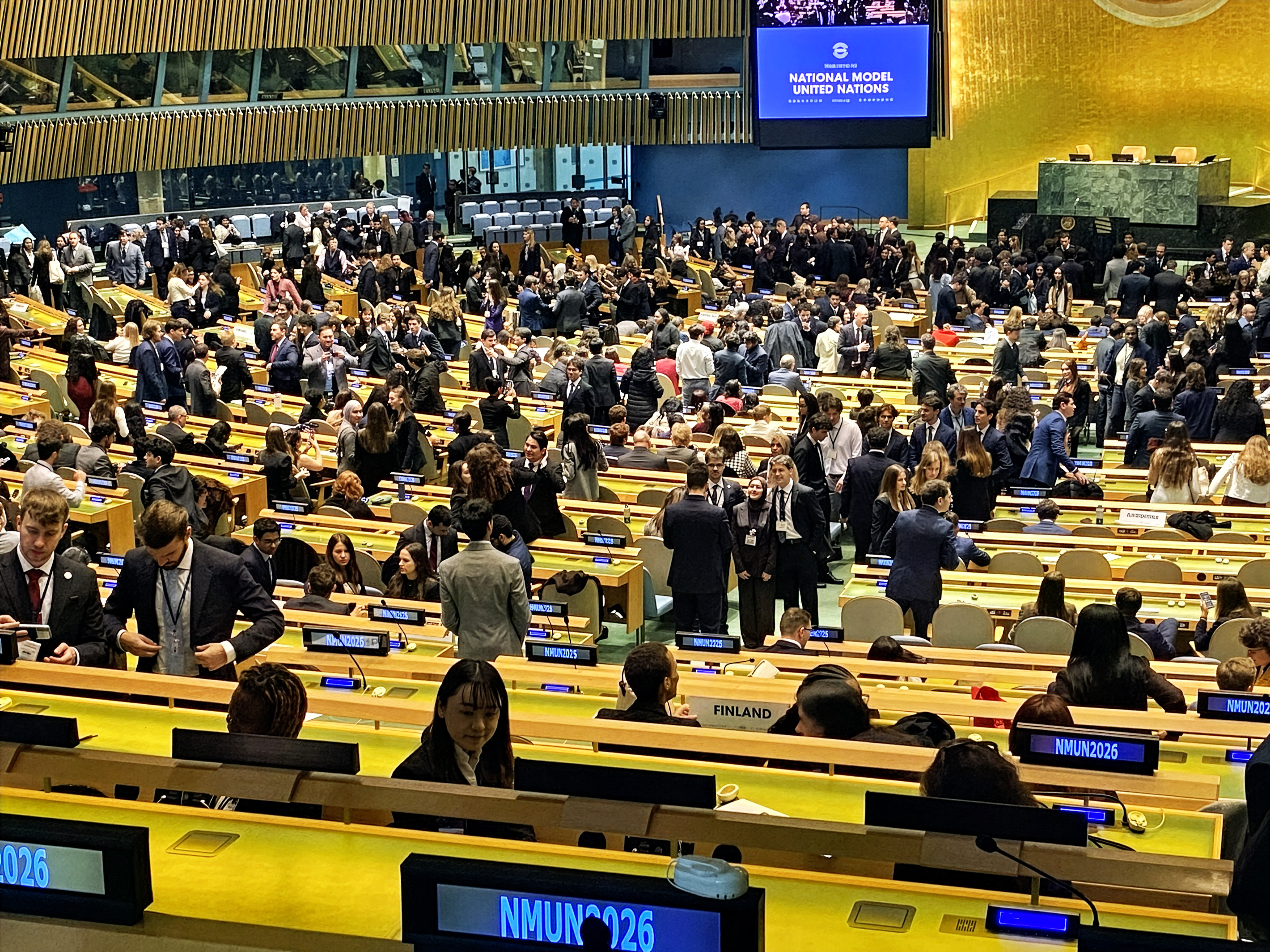 A crowded UN Great Hall is shown filled with delegates sitting in rows