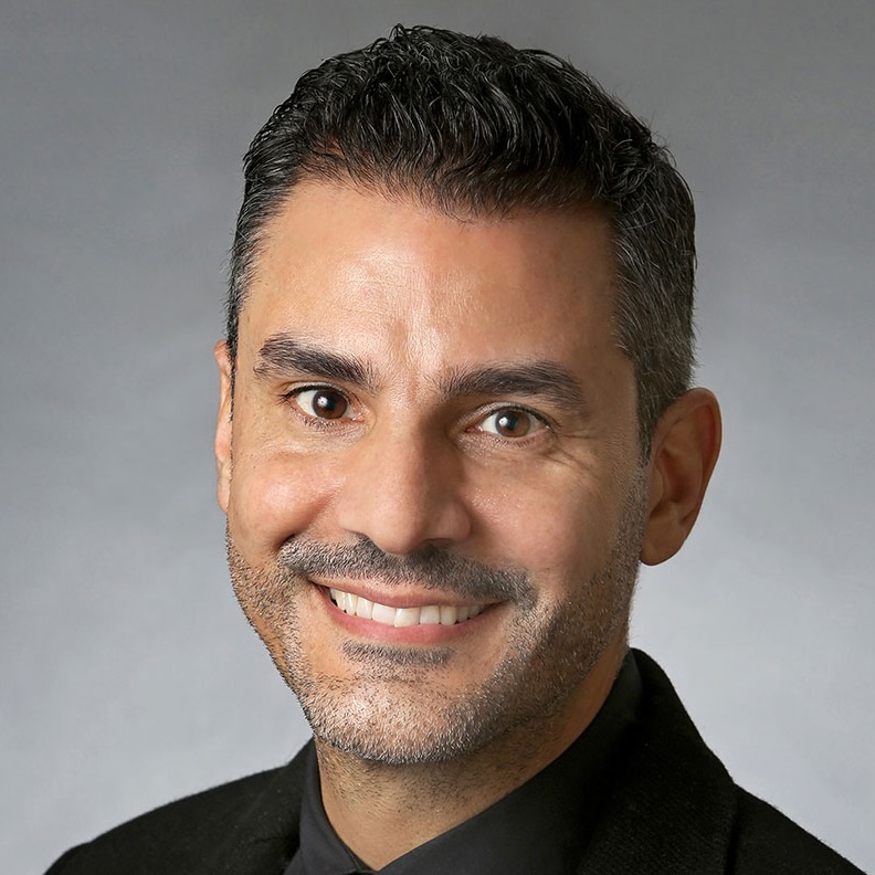 Headshot of Carlos Alamo.