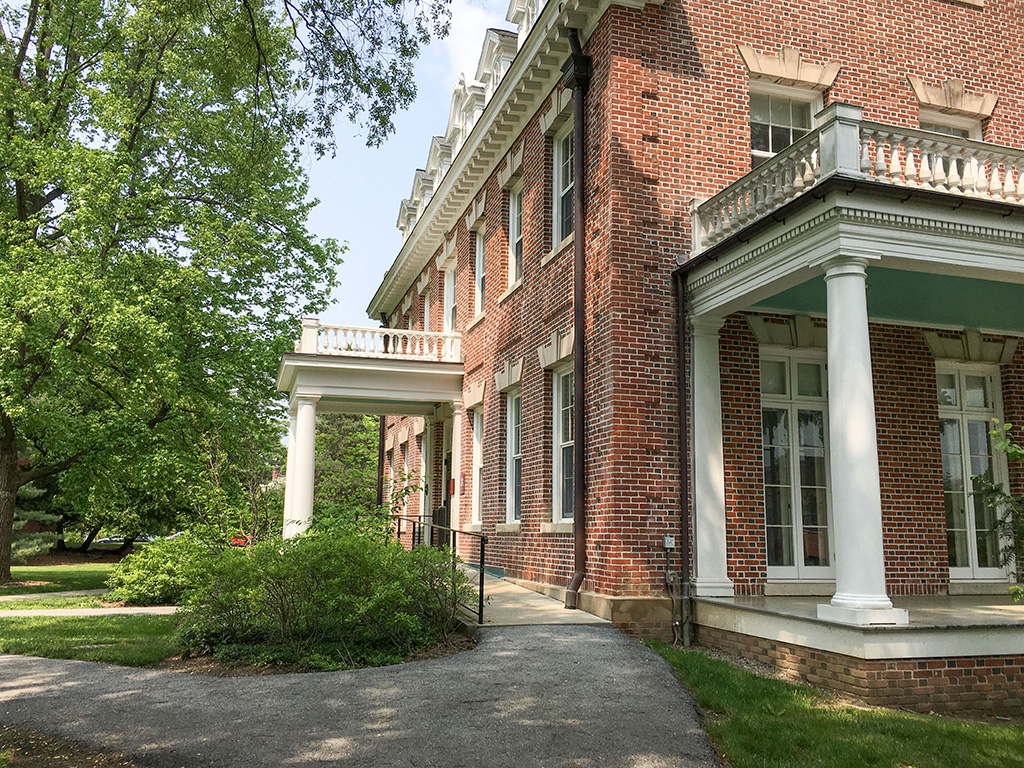 A brick building with a porch and a walkway.
