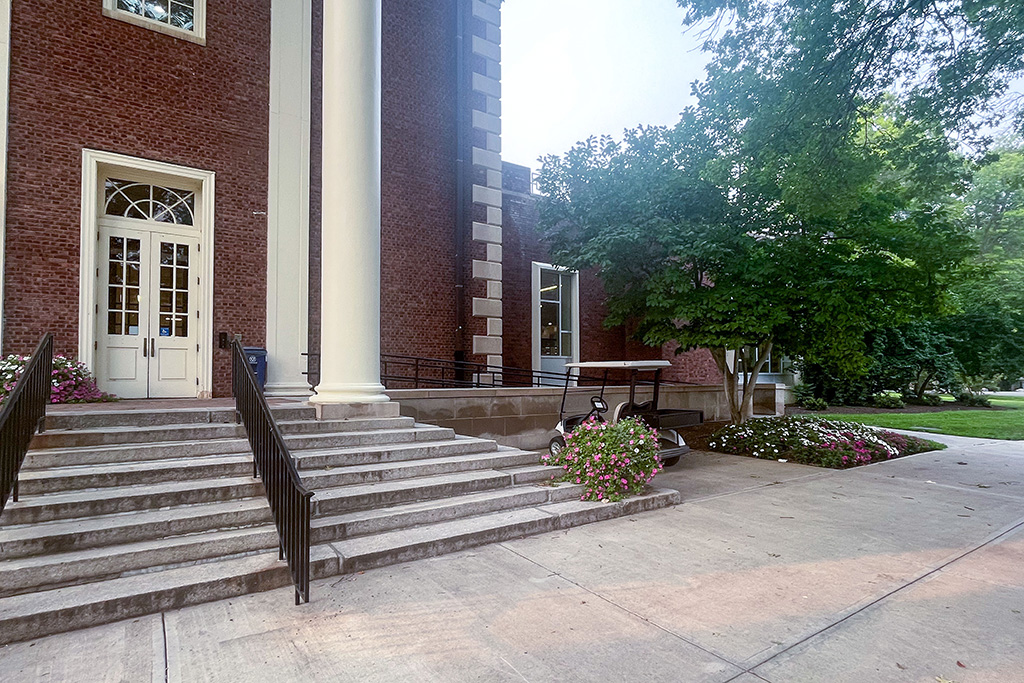 A brick building with a white column.