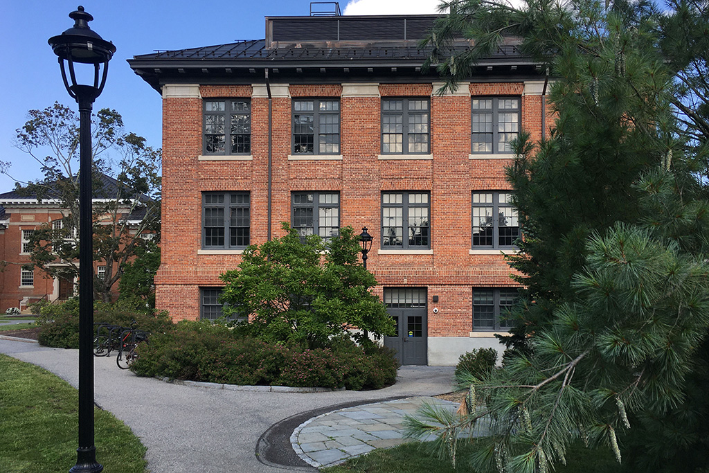 A brick building with trees and a path.