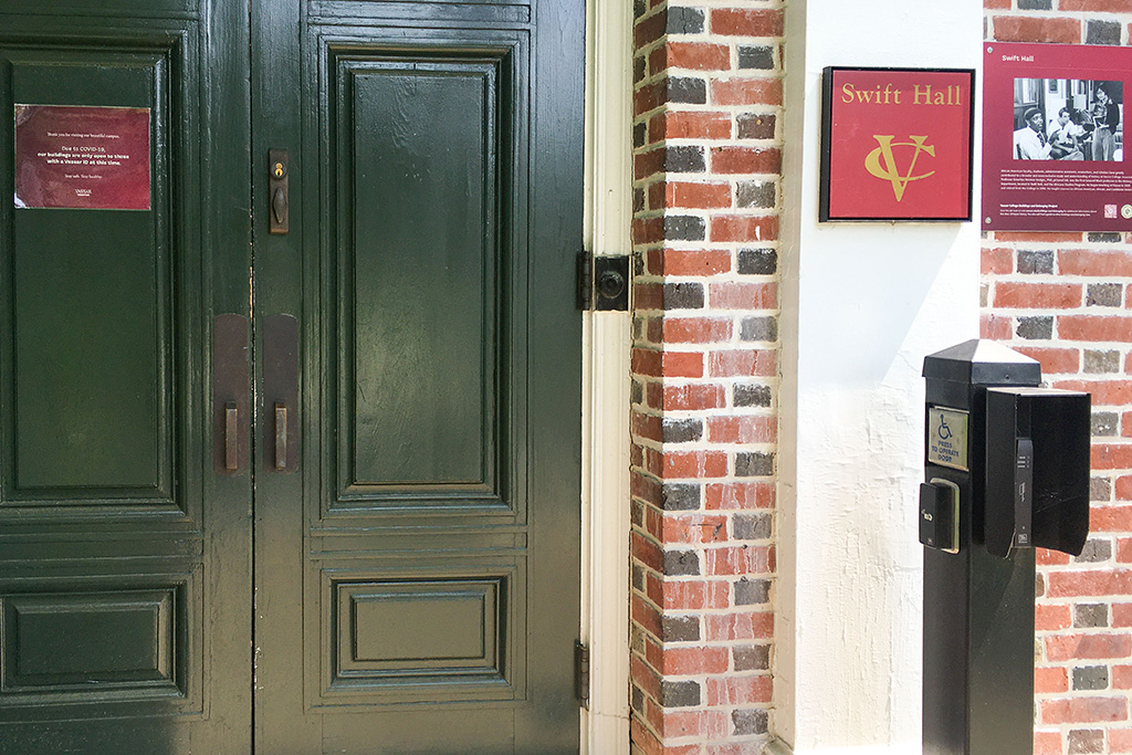 A green door next to a brick wall.