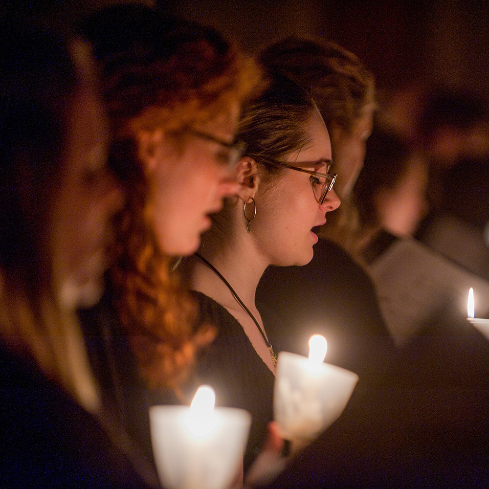 Choir members sing by candlelight during A Service of Lessons and Carols.