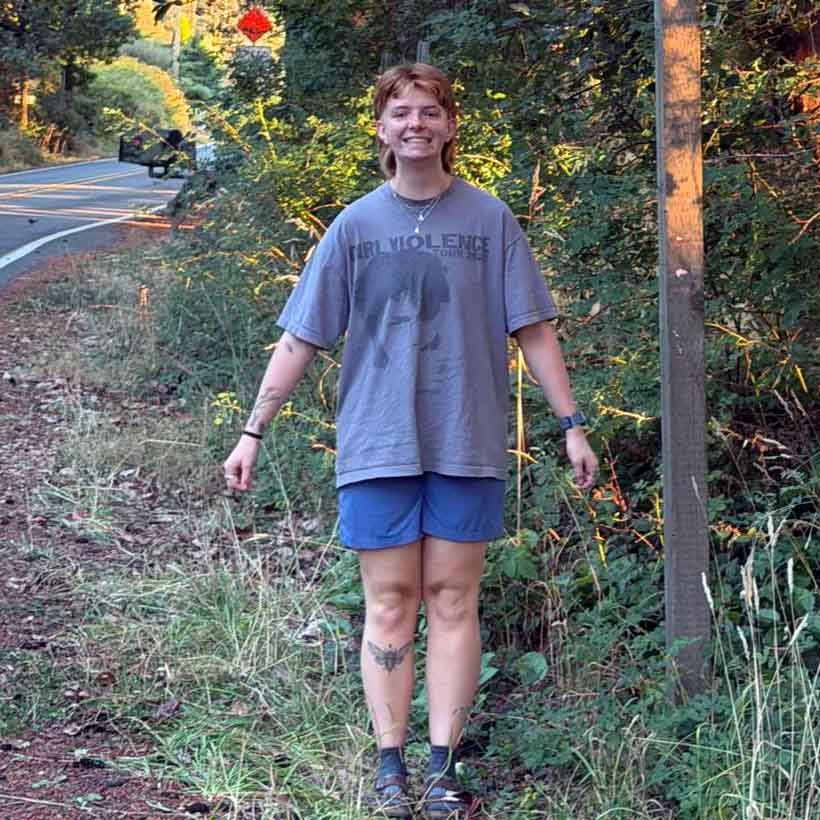 Photo of Eli Hoskison standing at the side of the road.