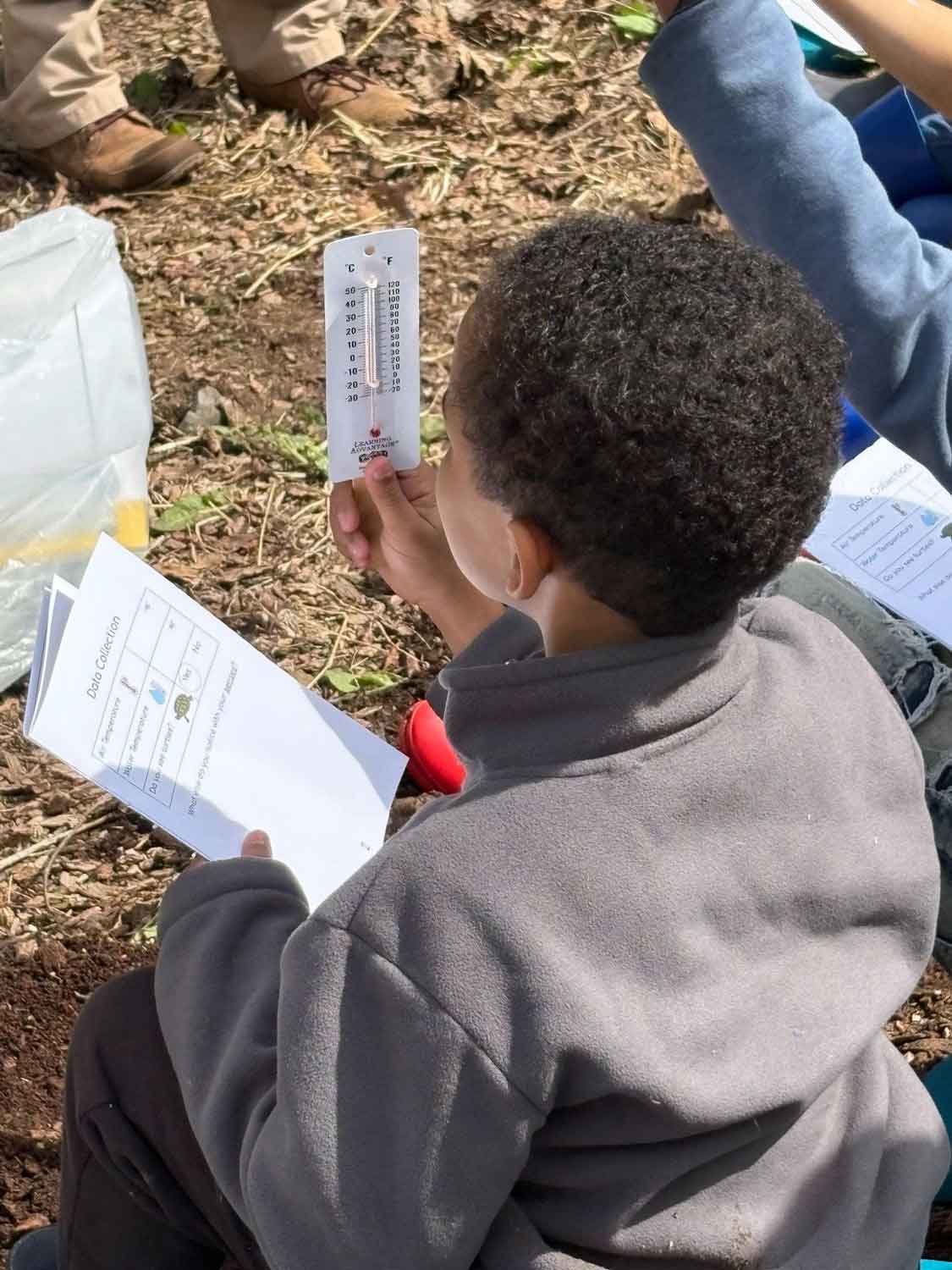 Child reading a thermometer.
