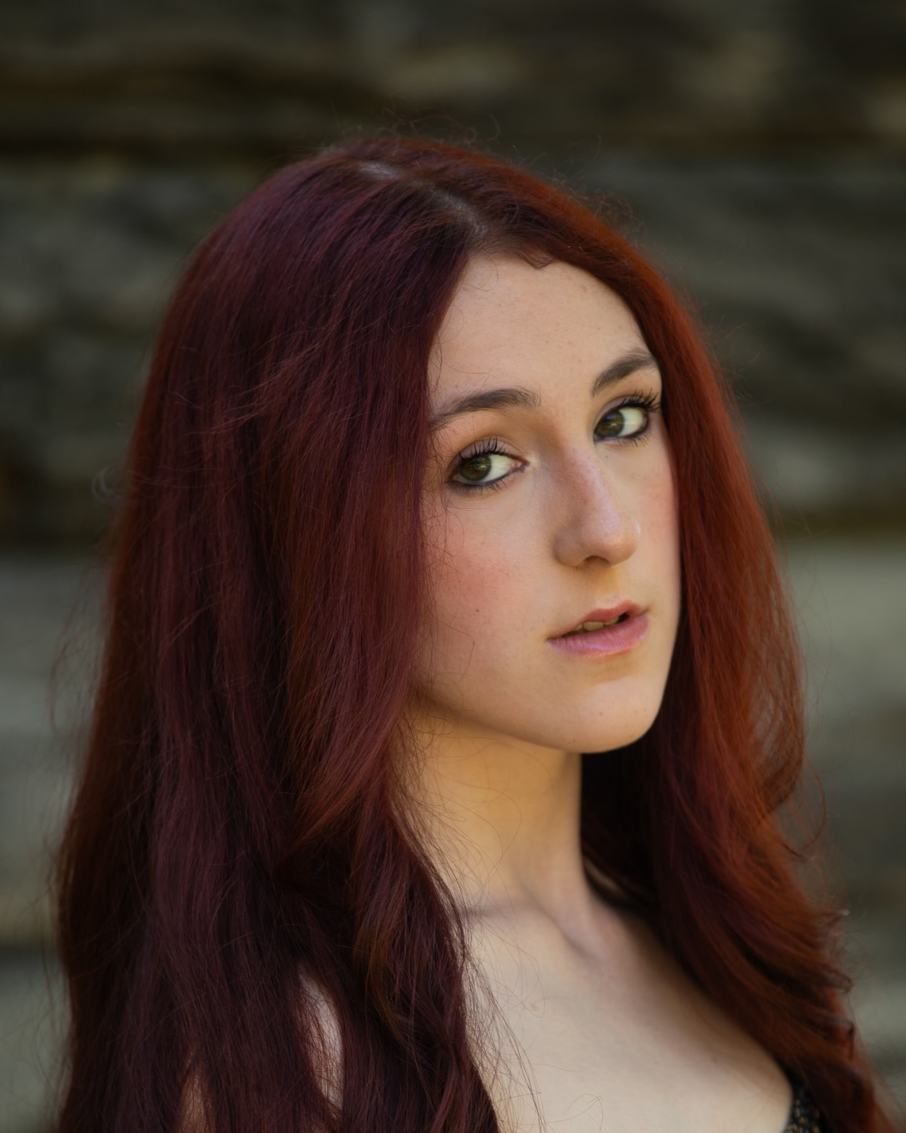 Portrait of a student outdoors with trees in the background.