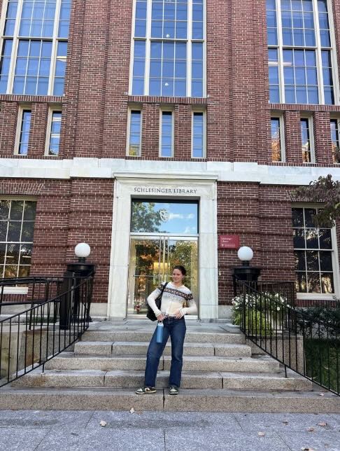 Person standing in front of a building entrance.