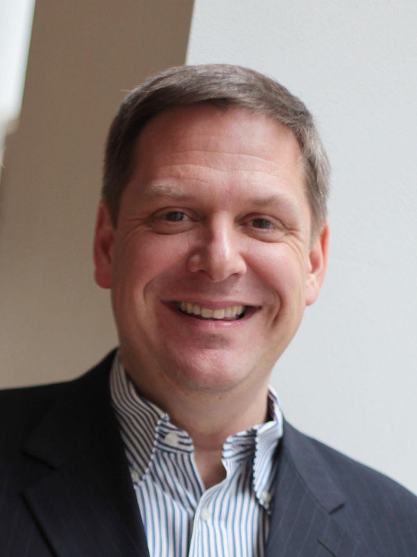 A photo of Andrew Solum ’89, a person with short brown hair and a dark gray jacket.
