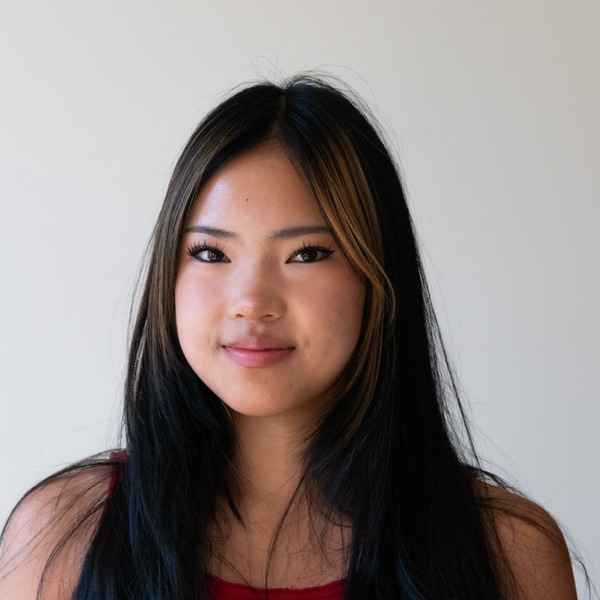 A portrait of Charlotte Huang, a person with black hair, wearing a red sleeveless top.