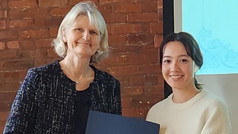 President Bradley with a student receiving an award certificate