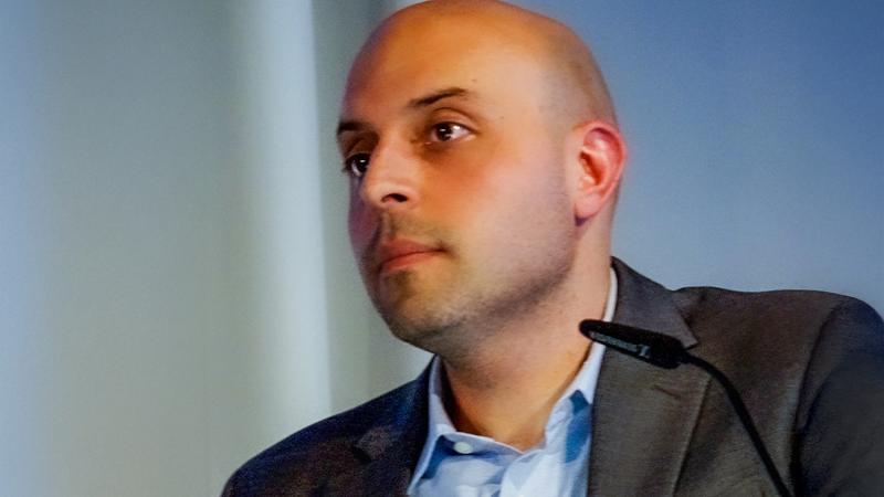 A person with a small microphone in from of them.