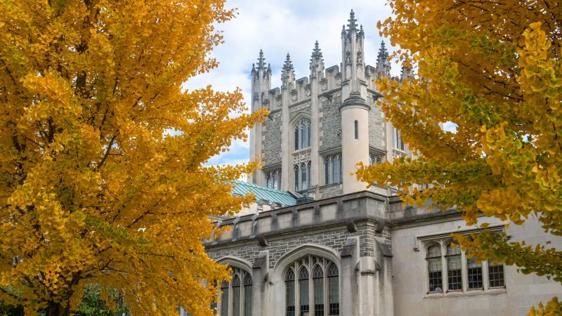 Exterior of a building nestled among fall foliage.