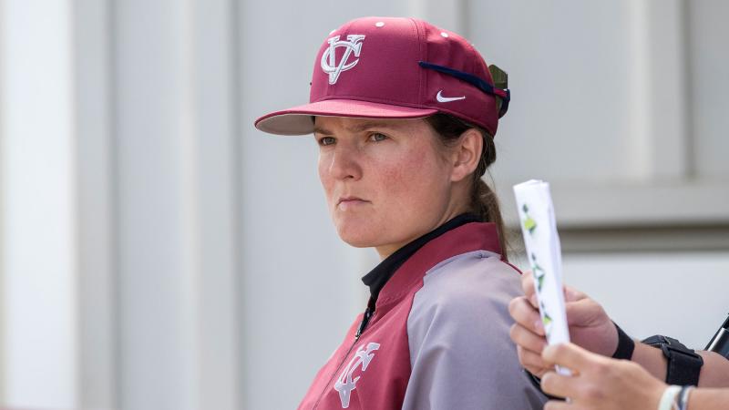Person wearing a baseball cap staring off screen intensely.