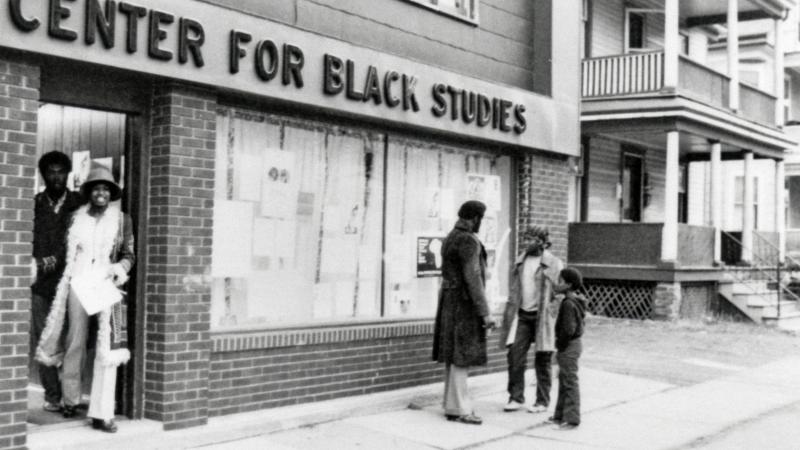 People outside of a building with a sign that reads: Center for Black Studies.
