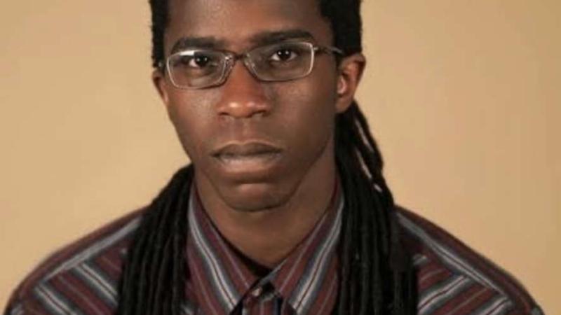 A photo of Cameron McKinney, a person with long black hair and glasses.